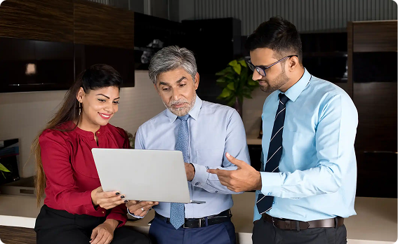 Team of colleagues reviewing results together on a laptop