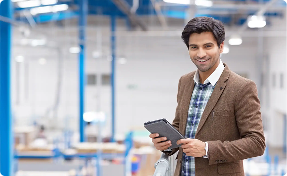 Professional holding a tablet on the factory floor