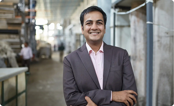 Smiling professional standing in a manufacturing facility